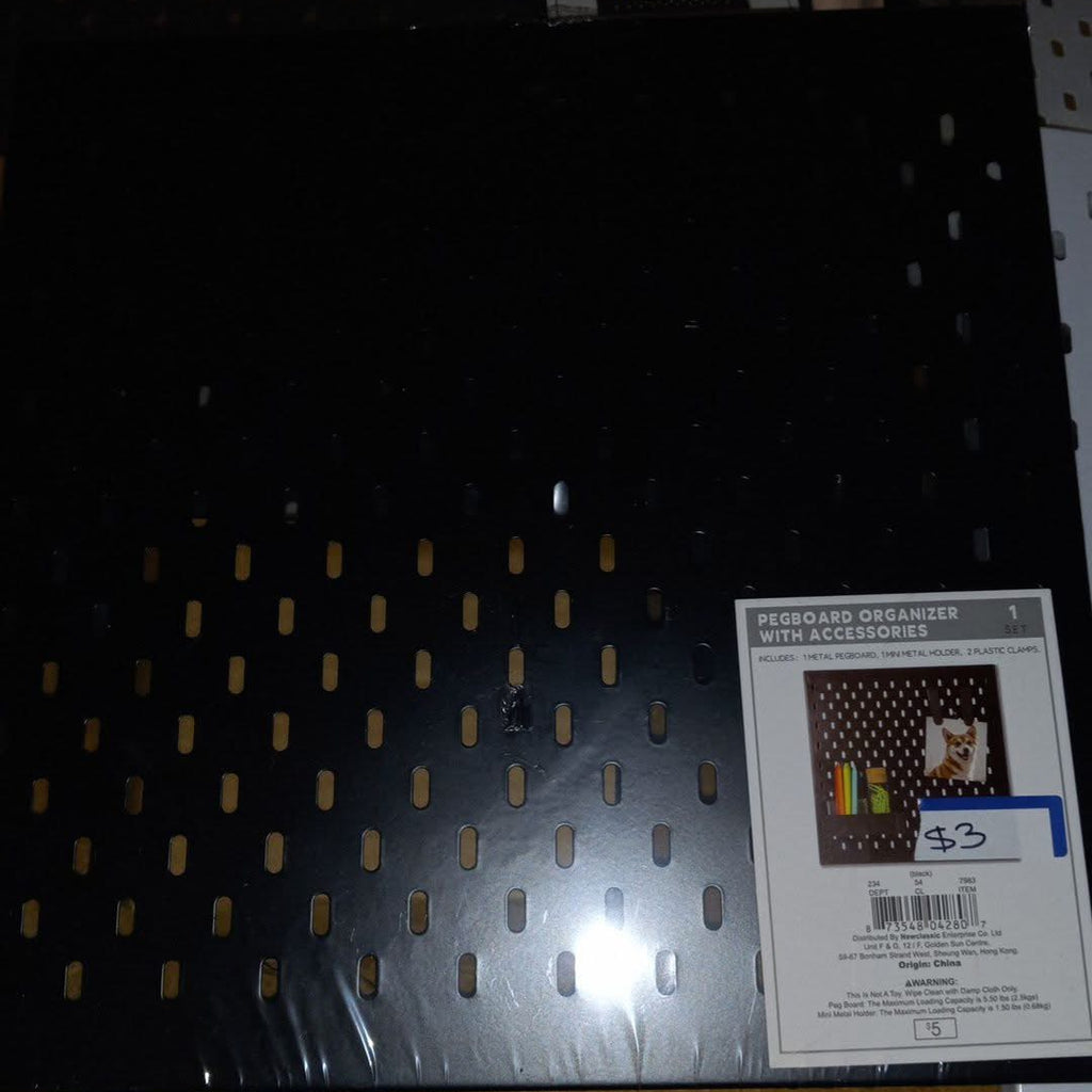 Black pegboard organizer with accessories