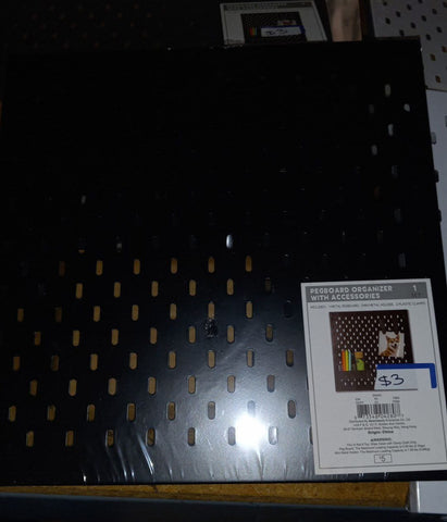 Black pegboard organizer with accessories